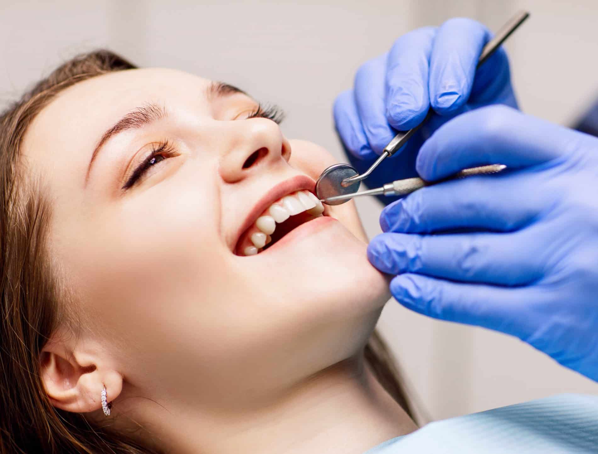 Woman recieving a dental cleaning in castle rock CO