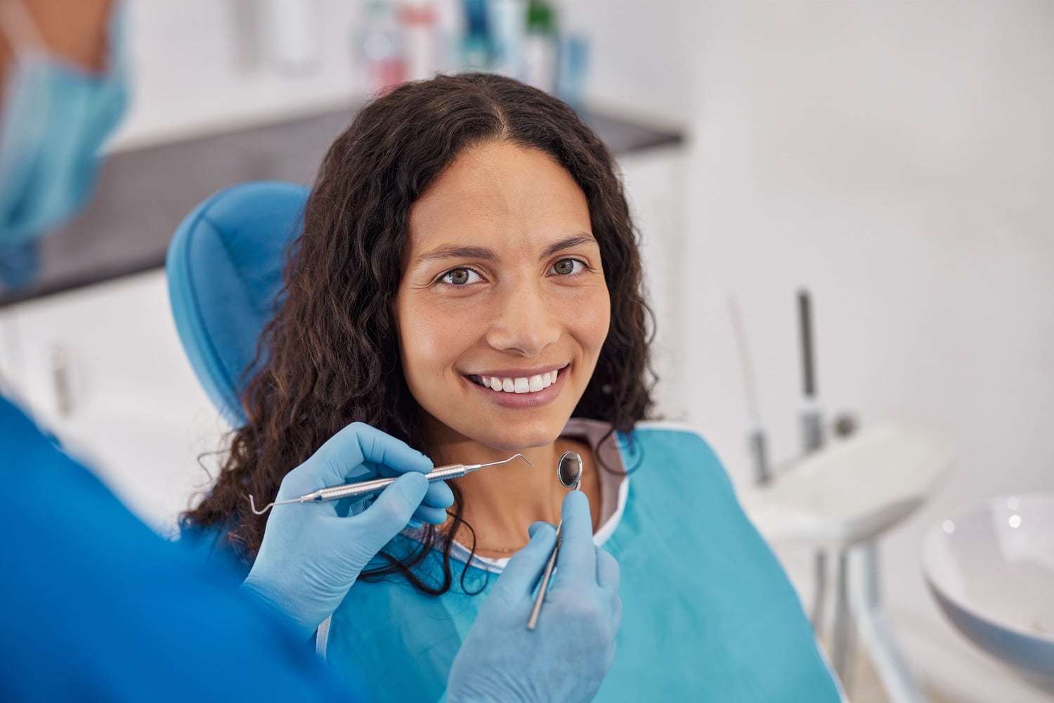 Woman smiling at her single tooth implant appointment in Castle Rock
